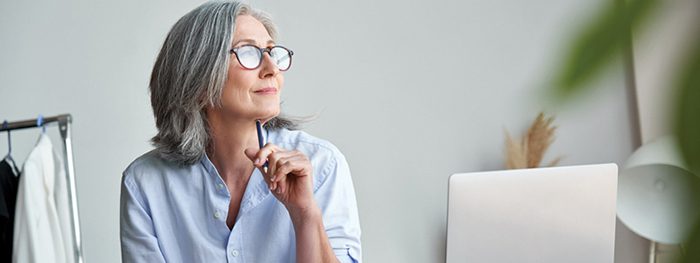 Thoughtful woman with laptop